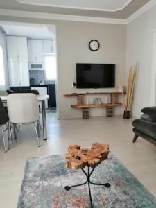 a living room with a tv and a table in a room at Villa angel in Sarigerme