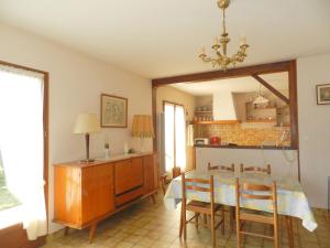 une cuisine et une salle à manger avec une table et des chaises dans l'établissement Maison à 8min de plage Giraudière, à Grand-Village-Plage