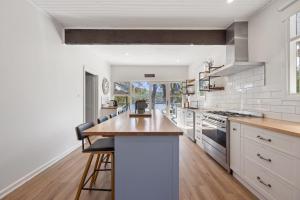 a kitchen with white appliances and a wooden counter top at Paradise Retreat Lakehouse - Jamieson - Sleeps 10 in Jamieson