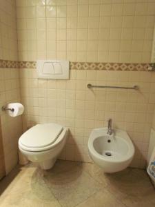 a bathroom with a toilet and a bidet at House in the convent in Chiavari +11 photos