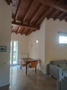 a living room with a table and a couch at House in the convent in Chiavari