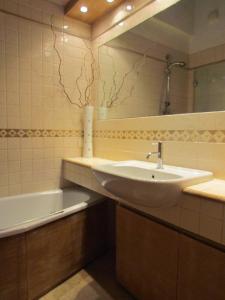 a bathroom with a sink and a mirror and a tub at House in the convent in Chiavari