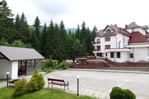 a parking lot with a bench in front of a building at GO GO Holiday in Borovets