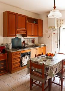 a kitchen with a table with a bowl of fruit on it at JO & NA in Lanciano
