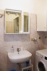 a bathroom with a sink and a washing machine at JO & NA in Lanciano +34 photos