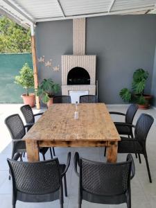 a dining room with a wooden table and chairs at Villa angel in Sarigerme
