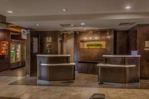 a lobby with wooden walls and a counter in a building at Courtyard Greensboro Airport in Greensboro