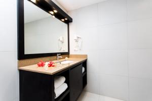 a bathroom with a sink and a mirror at Plantation Island Resort in Malolo Lailai