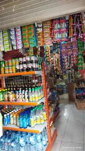 a store with a shelf filled with lots of drinks at Dody Guest House in Undisan