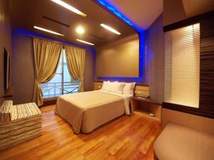 a bedroom with a bed and a large window at Ibizakenting Hotel II in Kenting