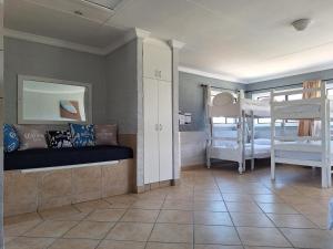a room with two bunk beds and a room with twounks at Pili Pili Beach Cabanas in Sedgefield