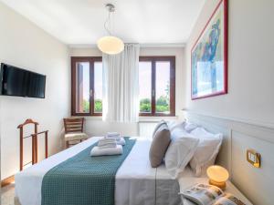 Ένα ή περισσότερα κρεβάτια σε δωμάτιο στο Borgo Tabari Locazione Turistica