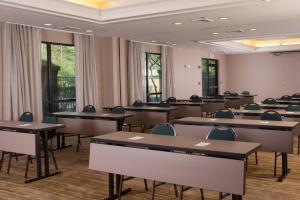 a classroom with tables and chairs in a room at Courtyard Greenville-Spartanburg Airport in Greenville
