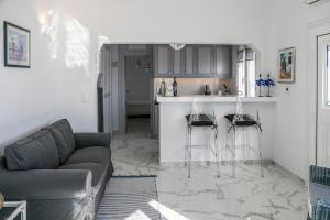 a living room with a couch and a kitchen at Mediterranean Beauty in Skiathos