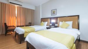 Postel nebo postele na pokoji v ubytování Bliss Hotel San Fernando Pampanga City