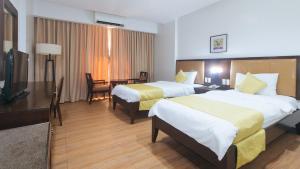 Postel nebo postele na pokoji v ubytování Bliss Hotel San Fernando Pampanga City
