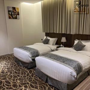 Postel nebo postele na pokoji v ubytování Rafid Hotel Jazan - فندق رفيد جازان
