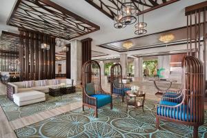 a rendering of a lobby with blue chairs and a couch at Renaissance Danang Hoi An Resort & Spa in Hoi An