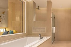 a large bathroom with a tub and a shower at Le Meridien Khao Lak Resort & Spa in Khao Lak +128 photos