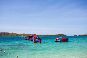 a row of inflatable boats in the water at Plantation Island Resort in Malolo Lailai