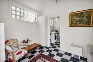 a living room with a chair and a checkered floor at Historic 4 Bedroom Townhouse in Launceston +27 photos