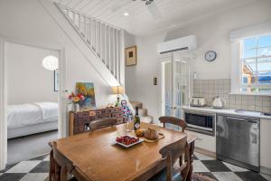 a kitchen and dining room with a wooden table at Historic 4 Bedroom Townhouse in Launceston