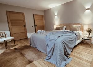 a bedroom with a large bed with towels on it at Burgundy Heritage Collection - Refuge d'Exception au cœur d'Autun in Autun