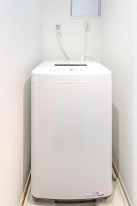 a white refrigerator in a corner of a room at SQ312-5 mins Shibuya Station JR Yamanote - Max 2 in Tokyo