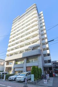 a tall white building with cars parked in front of it at SQ312-5 mins Shibuya Station JR Yamanote - Max 2 in Tokyo