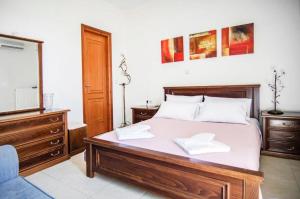 A bed or beds in a room at Villa Fotini with ocean view