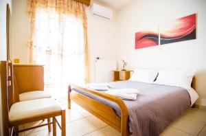A bed or beds in a room at Villa Fotini with ocean view