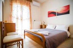 A bed or beds in a room at Villa Fotini with ocean view