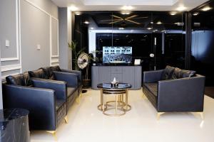 a lobby with couches and a table in a room at Luxvill Hotel in Islamabad