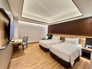 Postel nebo postele na pokoji v ubytování Orchardz Hotel Industri Jakarta Kemayoran