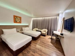 Postel nebo postele na pokoji v ubytování Orchardz Hotel Industri Jakarta Kemayoran