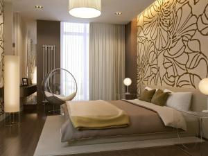 a bedroom with a large bed with a painting on the wall at ATRIA Mega Almaty in Almaty