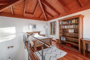 a bedroom with a bed and a book shelf at Casa Tagoro, facing the Ocean in Tacoronte