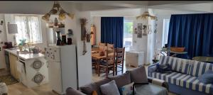 a living room with a kitchen and a dining room at K-Rooms in Veli Iž