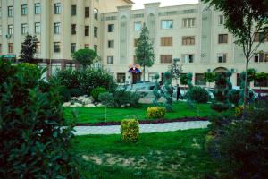 a building with a garden in front of a building at Tiny House Hotel in Samarkand