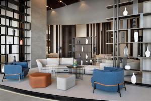 a living room with couches and chairs and a table at Courtyard by Marriott World Trade Centre, Dubai in Dubai