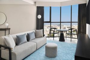 a living room with a couch and a table at Courtyard by Marriott World Trade Centre, Dubai in Dubai