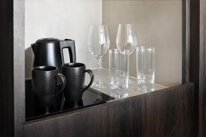 a shelf with cups and glasses on it at Courtyard by Marriott World Trade Centre, Dubai in Dubai