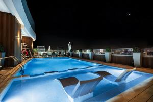 a large swimming pool on the roof of a building at Courtyard by Marriott World Trade Centre, Dubai in Dubai