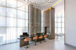 a lobby with a table and chairs and large windows at Courtyard by Marriott World Trade Centre, Dubai in Dubai
