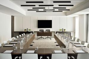 a conference room with tables and chairs and a projection screen at Courtyard by Marriott World Trade Centre, Dubai in Dubai +37 photos