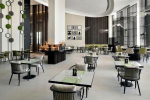 a dining room with tables and chairs and a restaurant at Courtyard by Marriott World Trade Centre, Dubai in Dubai