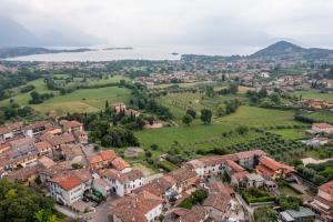 an aerial view of a town with houses and trees at La Còrt Apartments - Number 5 in Manerba del Garda +1 photo