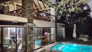 a house with a swimming pool and a patio at Loerie Escape - Marloth Park in Marloth Park +36 photos
