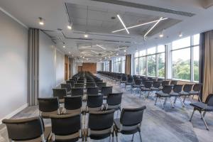 a large room with rows of chairs and windows at Courtyard by Marriott Katowice City Center in Katowice
