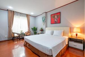 Postel nebo postele na pokoji v ubytování La Palma - Garden Saigon Hotel Phu My Hung